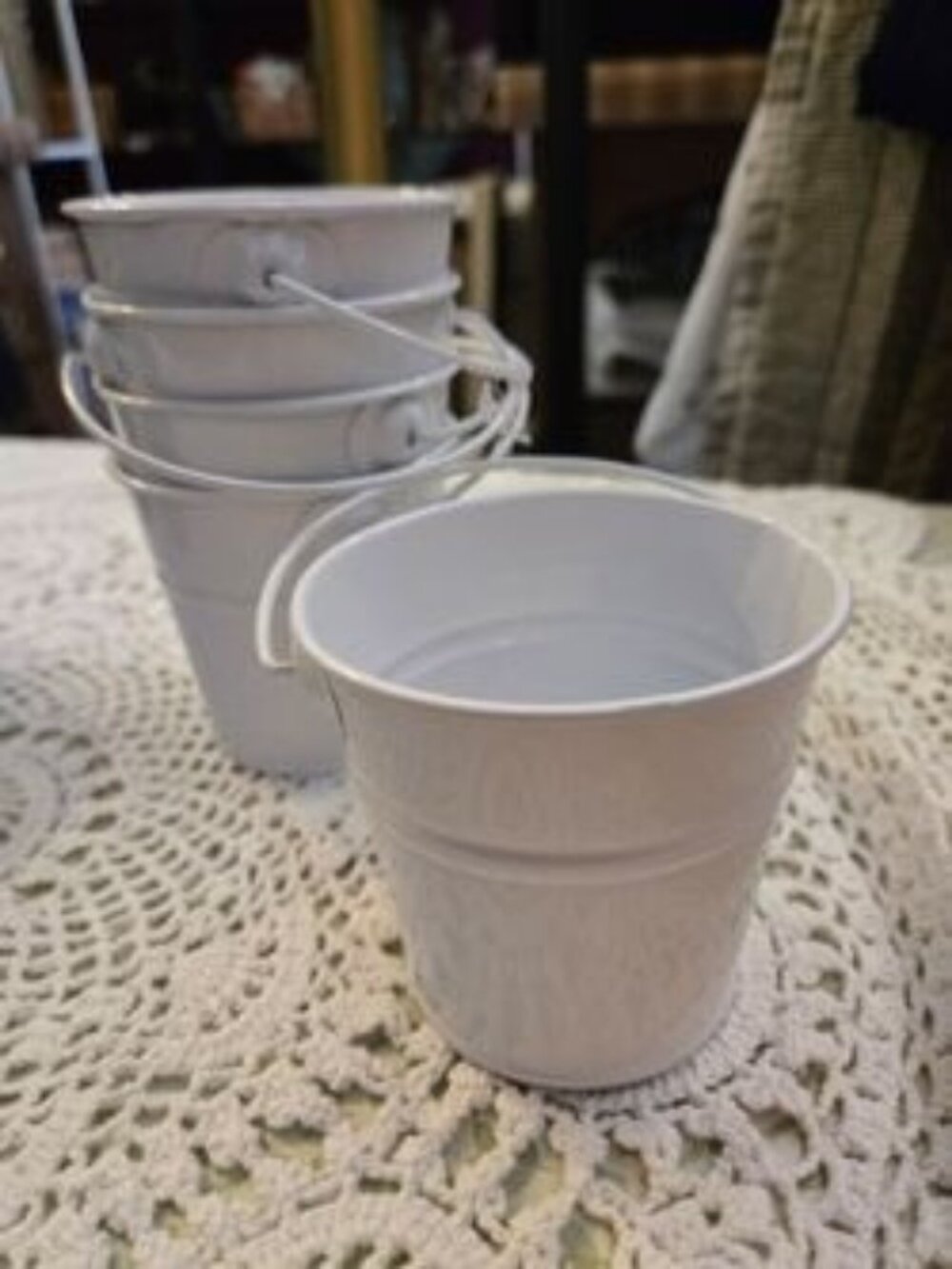 5 white metal buckets